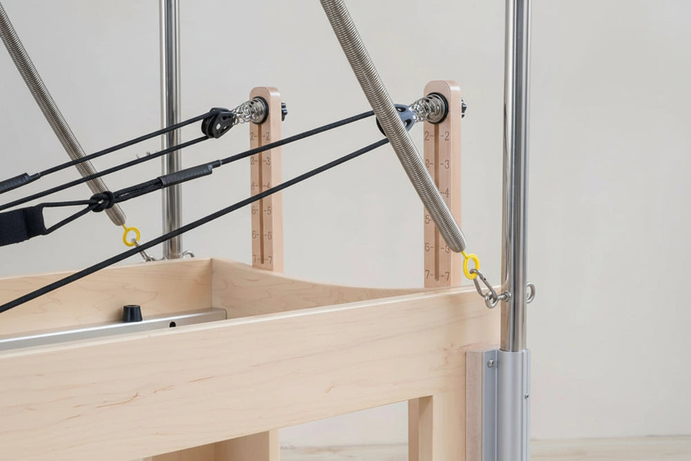 Wooden reformer with cables attached, branded on a light background