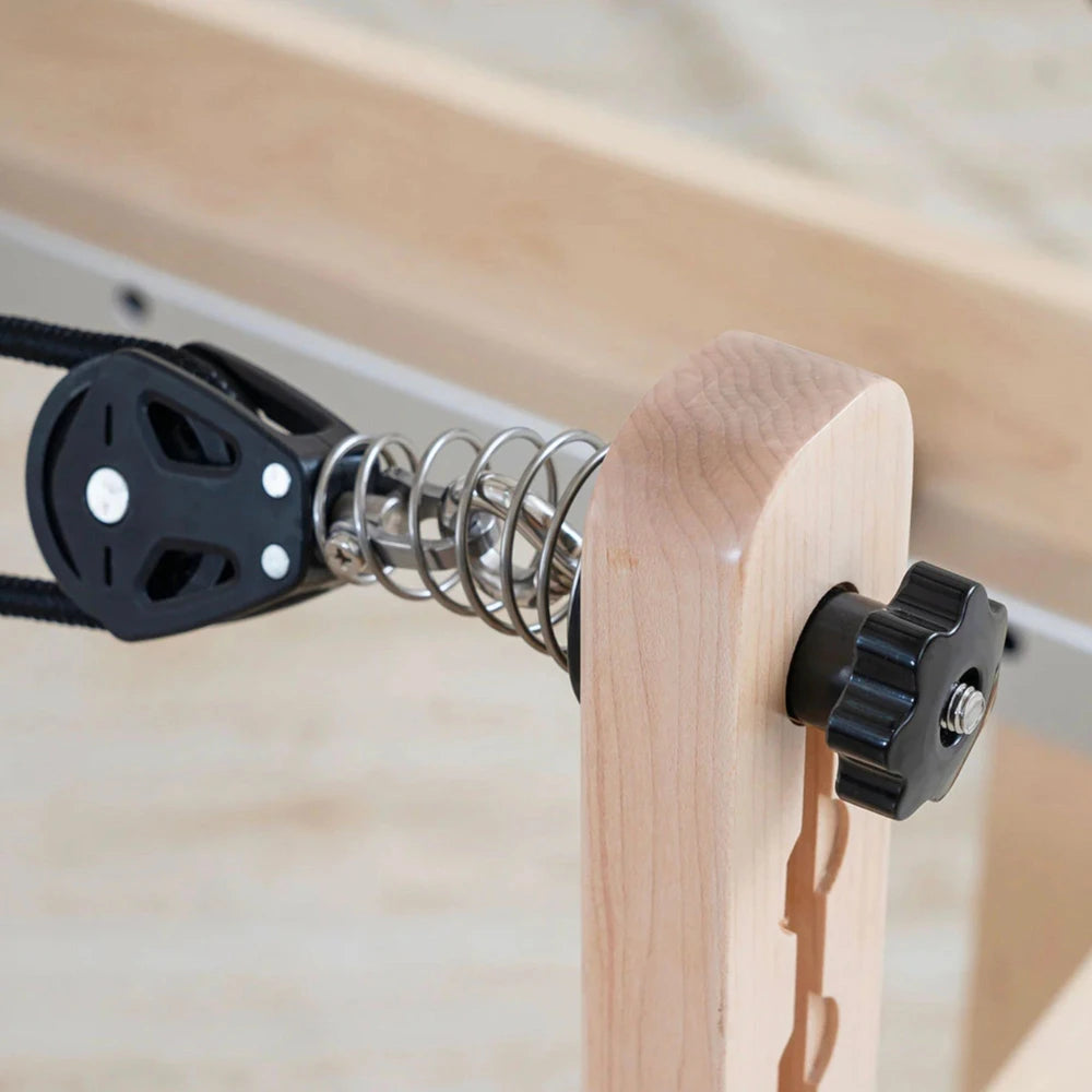 Pulley and spring assemble of the rope system in a pilates reformer machine