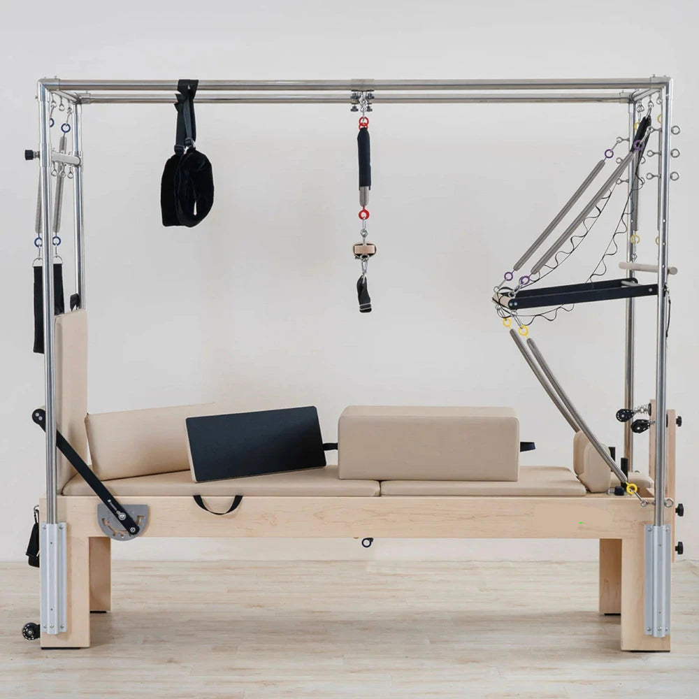 Pilates reformer machine with attachments on a white background