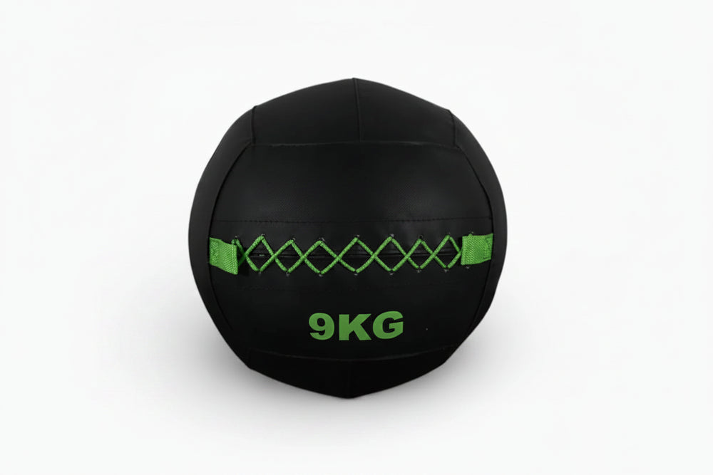 Black wall ball with green accents on a white background