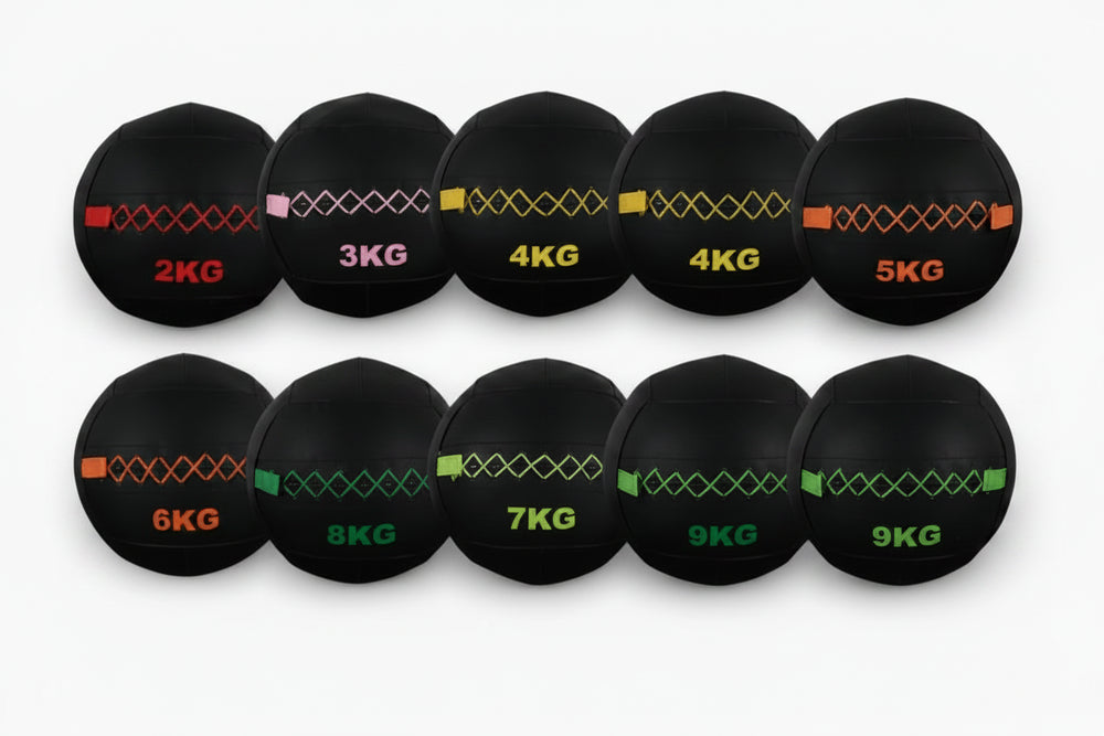 Set of black weighted balls with visible weight labels on a white background