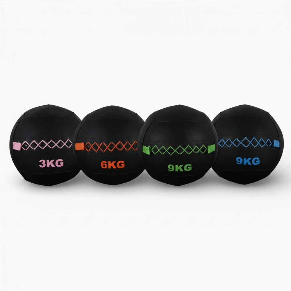 Four black weighted balls with different weights on a white background