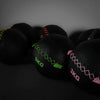 Black wall balls with weight markings on a dark background