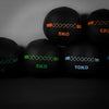 Set of black wall balls with weight markings on a gray background