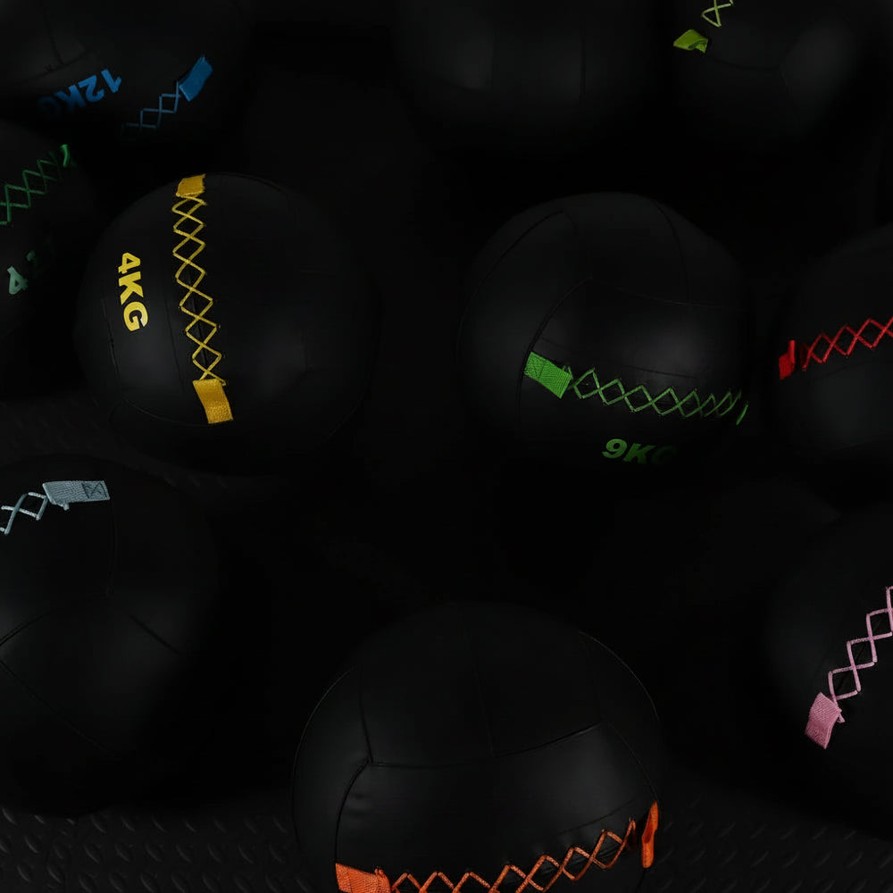 Group of wall balls with different weights on a dark background