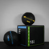 Bundle of two slam balls and gym box on a dark background