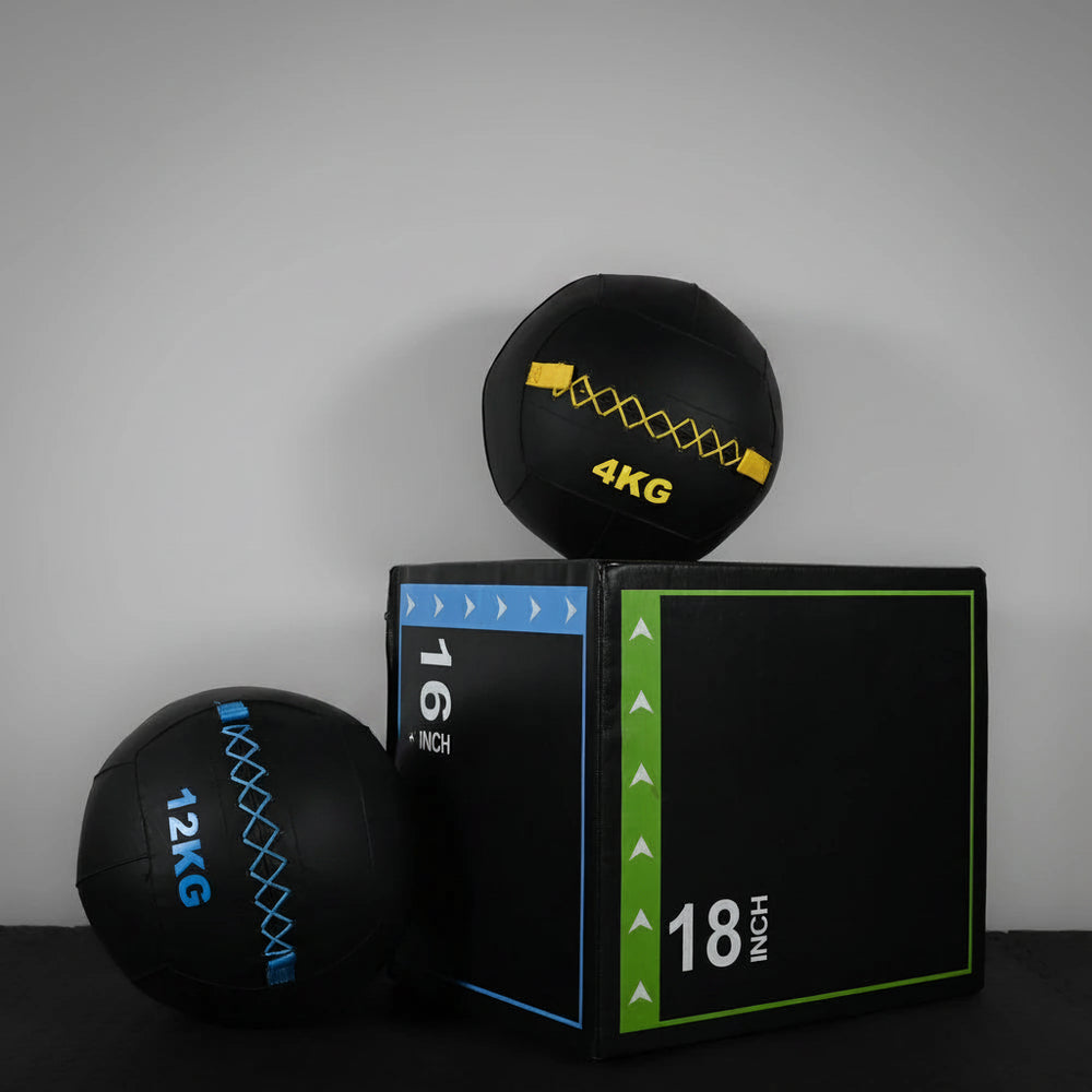 Bundle of two slam balls and gym box on a dark background