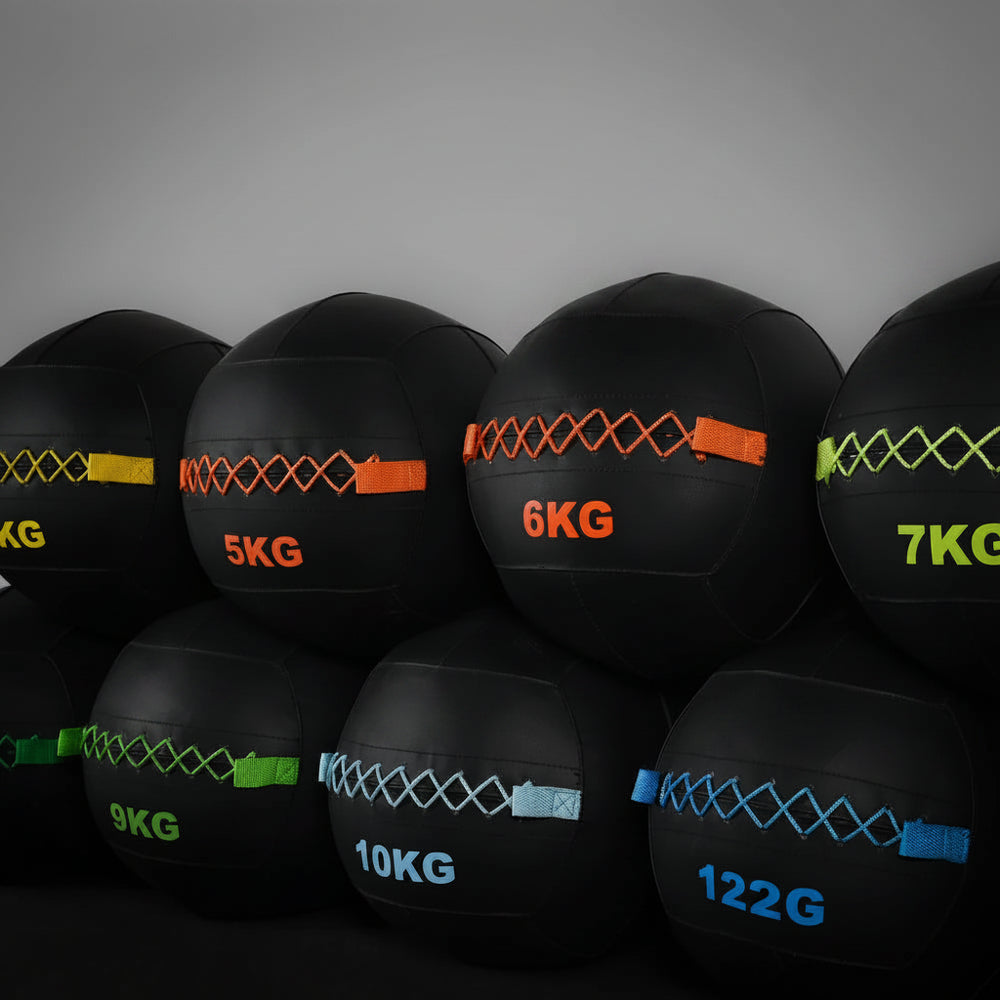Rows of slam balls at different weights and colour coding on a dark background