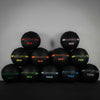 Set of weighted wall balls with weight markings on a dark background