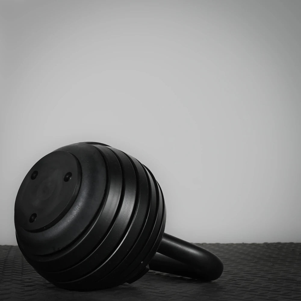Single kettlebell on a gym floor with a white background