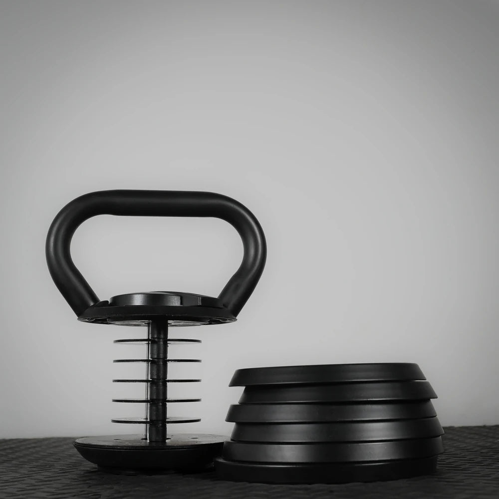 Adjustable kettlebell on black floor and white background