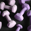 Purple dumbbells scattered on a dark floor