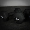 Black dumbbells with weight markings on a dark surface