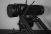 Weight loaded leg press and hack squat machine on a gray background