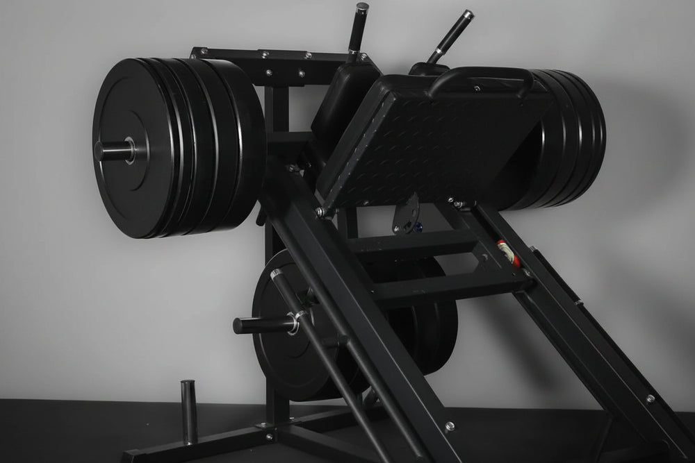 Weight loaded leg press and hack squat machine on a gray background