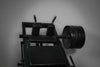 Leg press machine loaded with weight plates on a dark background