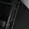 Black track of leg press machine against a dark background