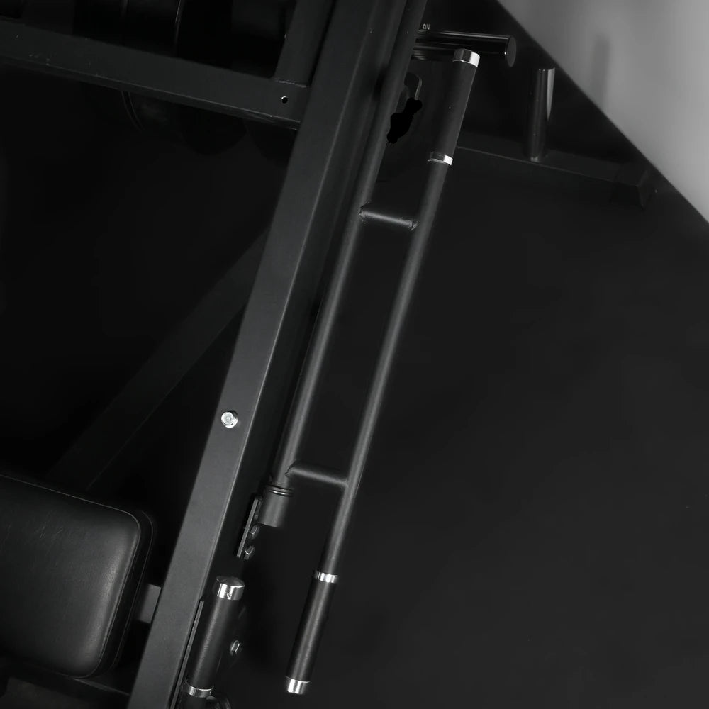 Black track of leg press machine against a dark background