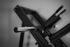 Black leg press and hack squat machine showing multiple bars on a gray background