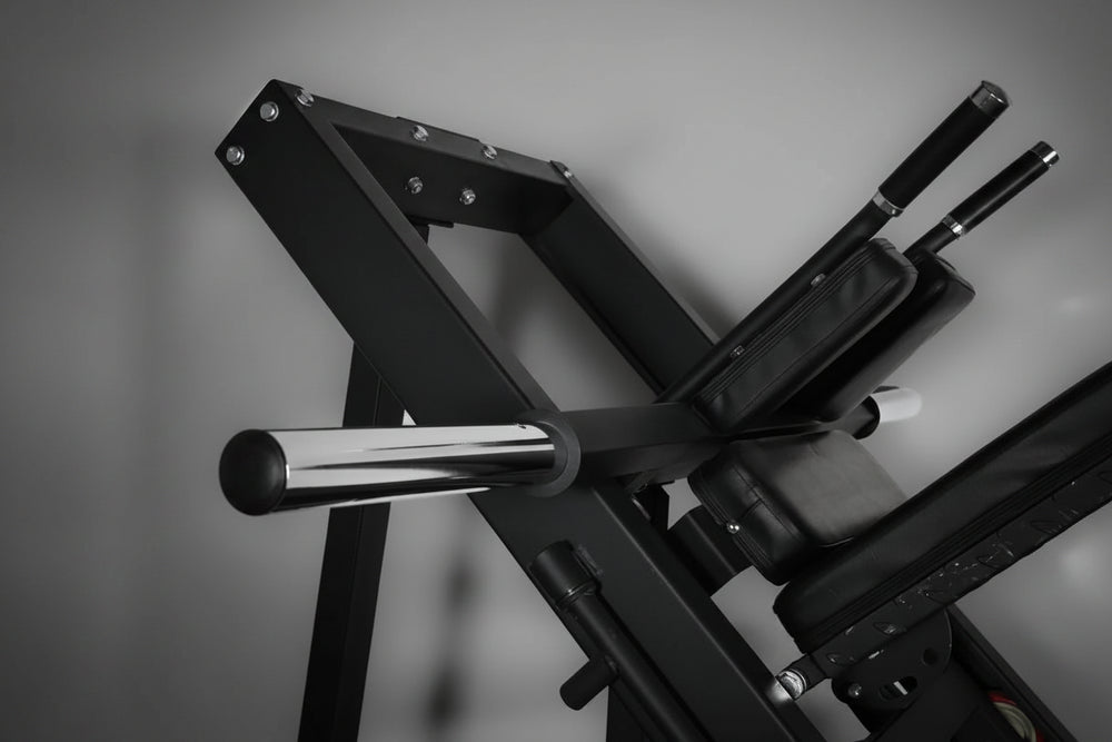 Black leg press and hack squat machine showing multiple bars on a gray background