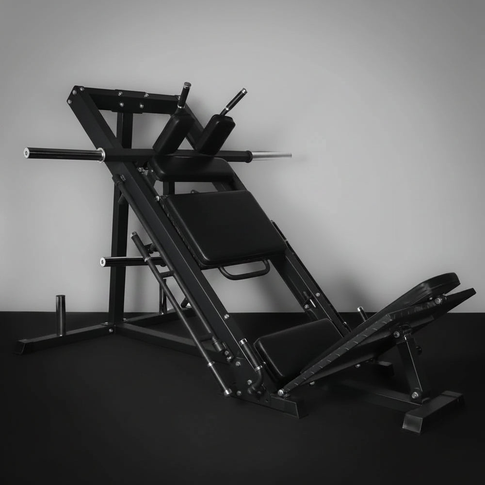 Commercial leg press and hack squat gym machine on a dark background
