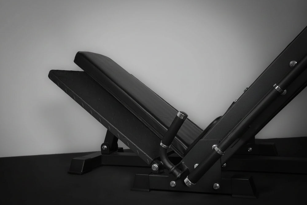 Black cushioned weight bench with on a gray background