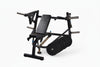 Black chest press machine with a set of weight plates on a white background