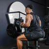 Man exercising on a weight machine in a gym setting