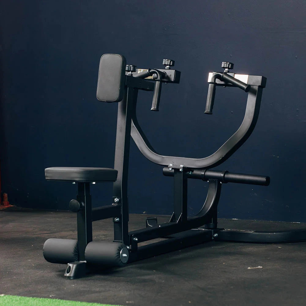 Black weight machine against a dark blue wall