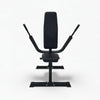 Black gym seated dip bench press machine on a white background