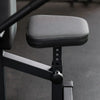 Seat of a seated dip machine on a dark background