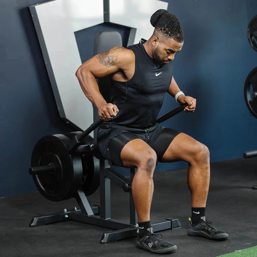 Man exercising with a seat dip machine in a gym setting