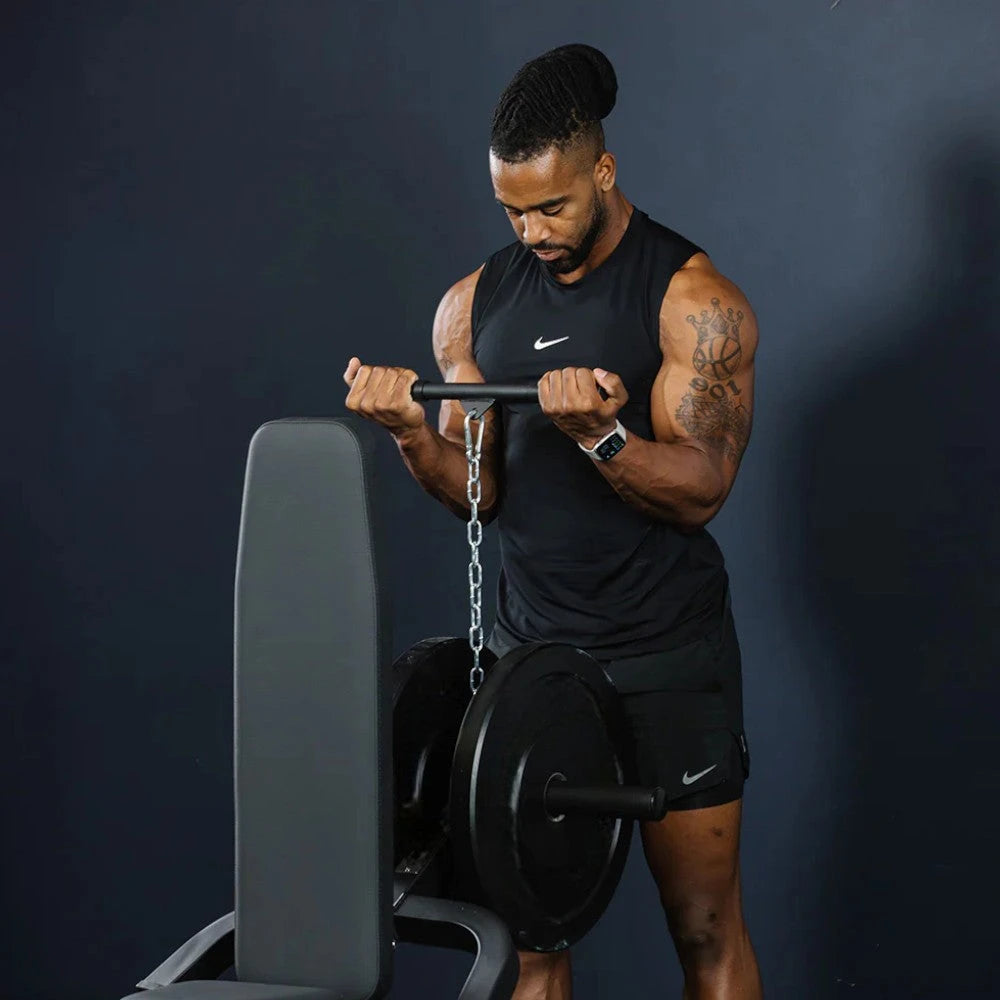 Man lifting a on a dip machine on a dark background