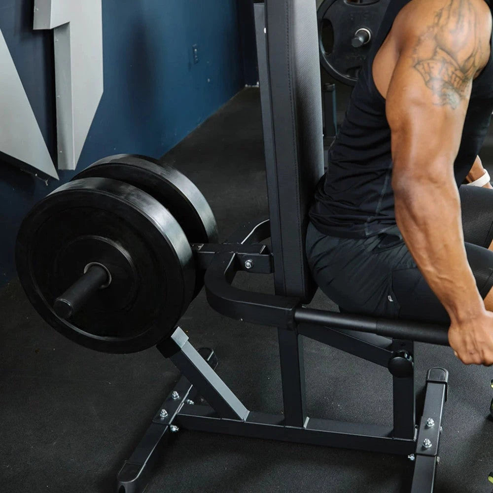 Person performing a seated dip press in a gym setting