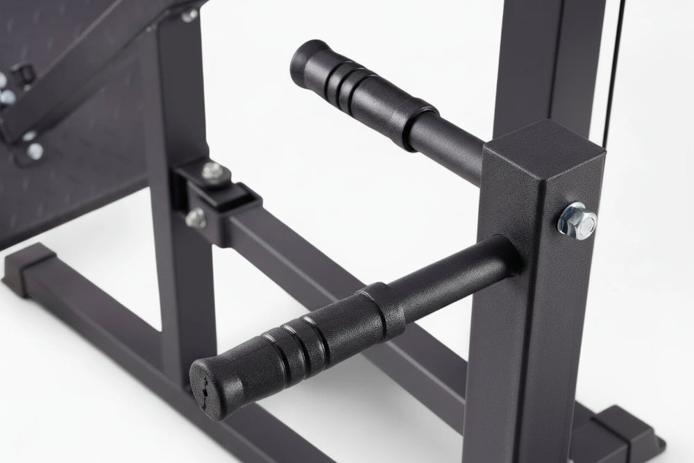Close-up of a black metal exercise machine on a white background
