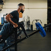 Man using a t row bar machine in a gym setting