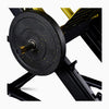 Close-up of a weight plate on a weightlifting bench with a white background