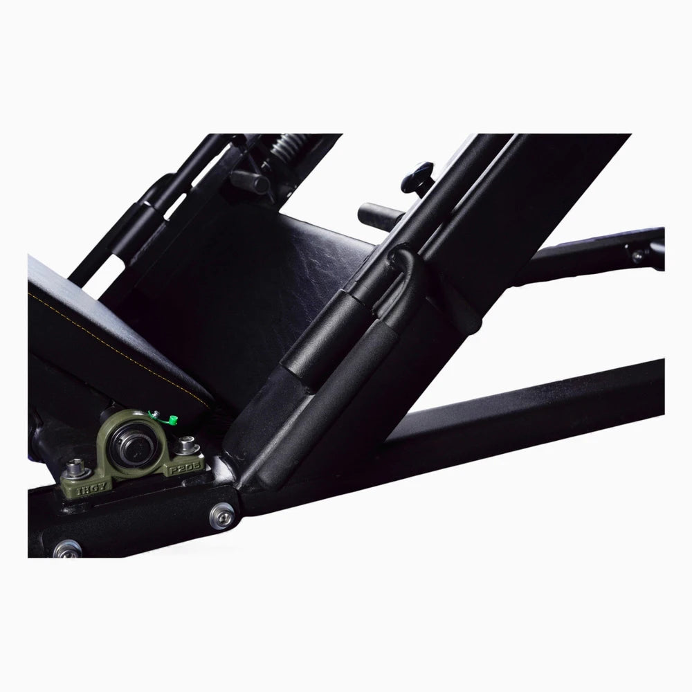 Close-up of a black metal frame of a leg press with mechanical components on a white background