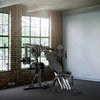 Gym machine in a room with brick walls and large windows