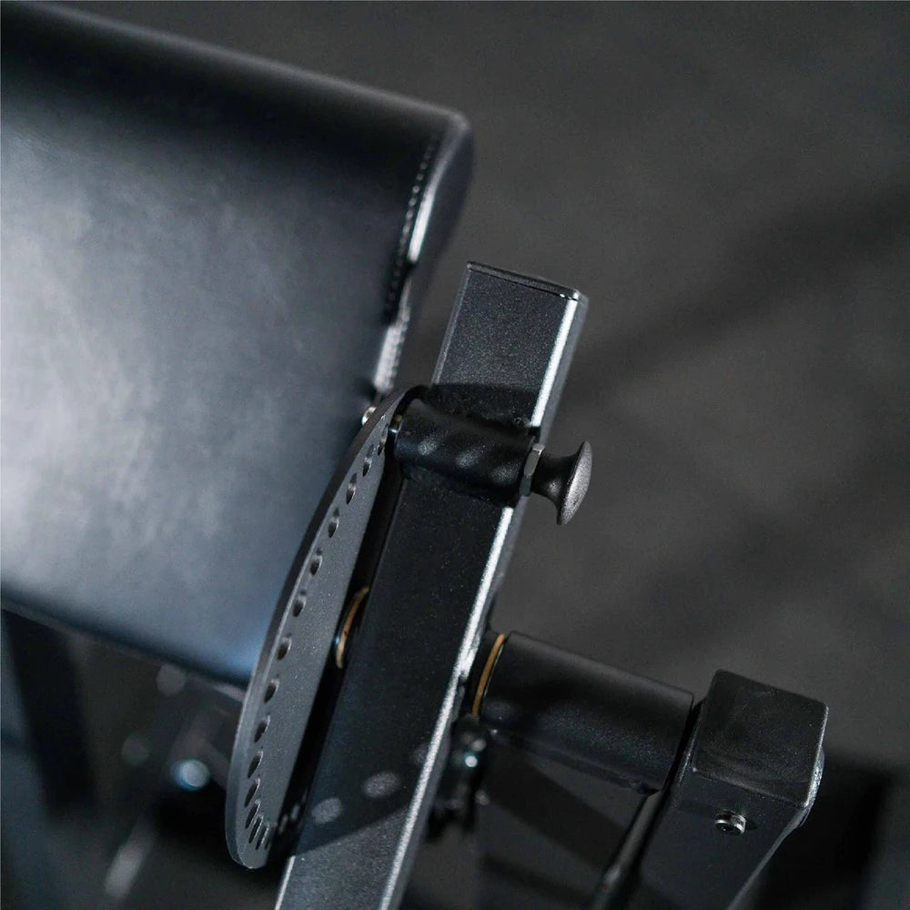 Close-up of a black leather cushion arm rest on a dark background