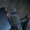 Close-up of a black leather cushion and adjustment dial on a dark background