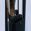 Stack of black weight plates on a gym machine with a blurred background