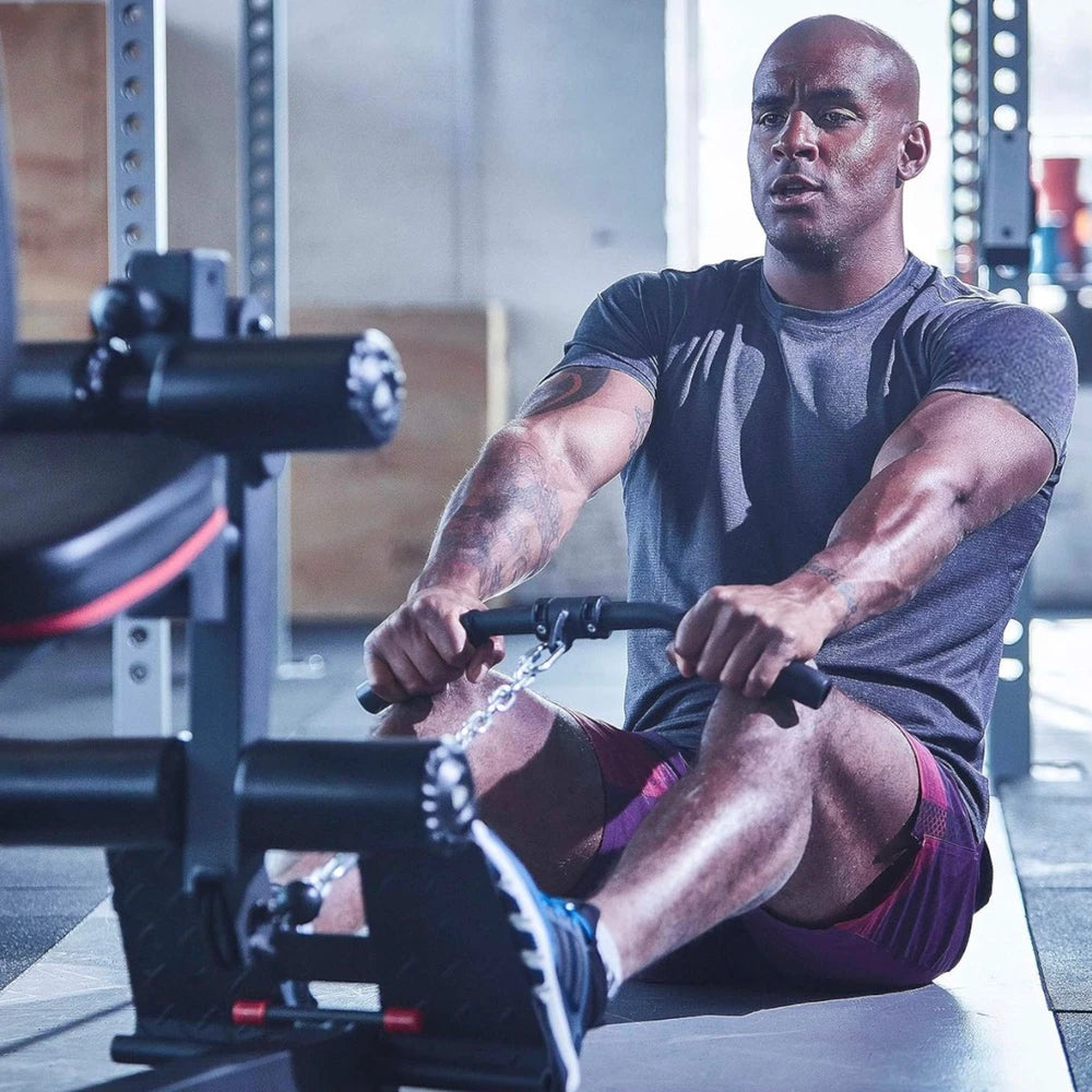 Man exercising on a multi gym machine in a gym setting