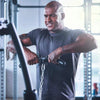 Man exercising in a gym using a pull up bar on a multi gym