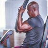 Man exercising on a machine in a gym setting