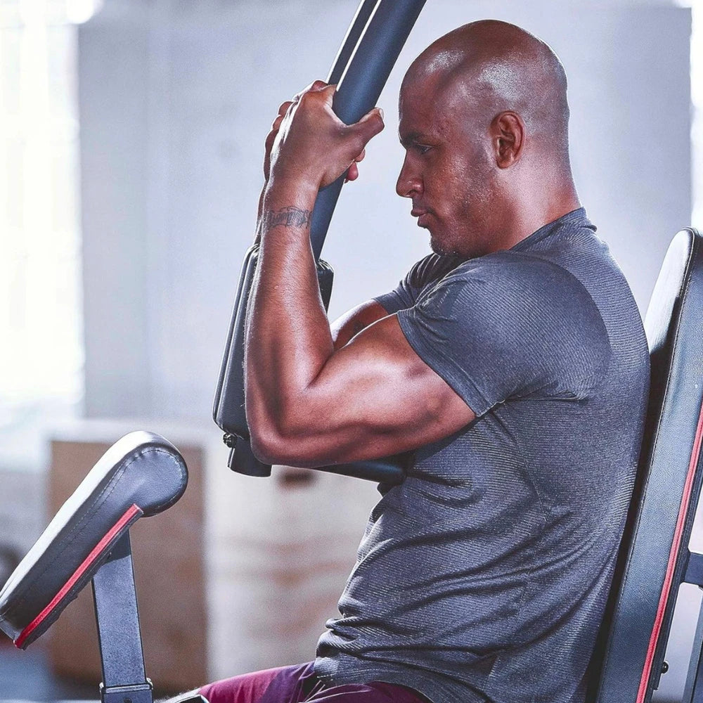 Man exercising on a machine in a gym setting