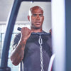 Man exercising with a weight machine in a gym setting