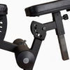 Adjustable seat on leg extension and curl machine on a white background
