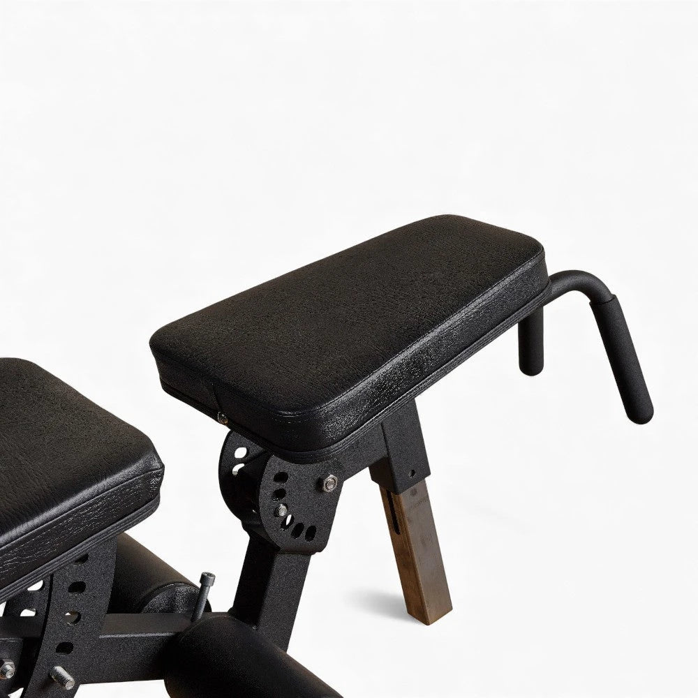 Padded cushion on a commercial Leg Extension and Curl Machine on a white background