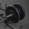 Plate loaded calf raise machine on a dark floor